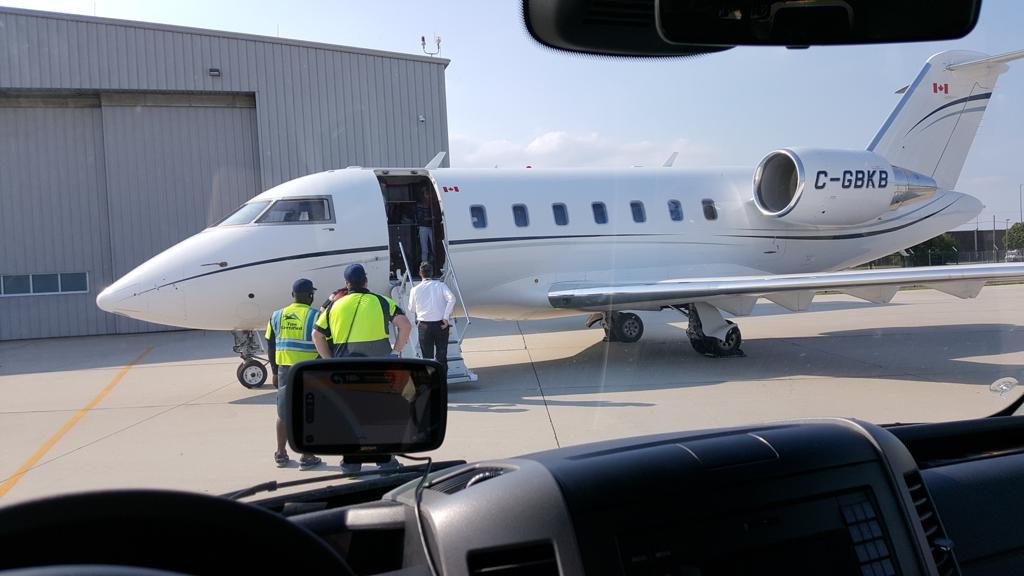 Jet plane at private Airport with sprinter van